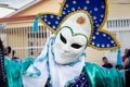 Closeup person in original motley mask poses for photo at dominican carnival