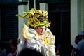 Closeup person in sparkling costume walks by city street on dominican carnival