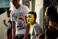 Closeup small boy in golden mask hides from tropical rain at dominican carnival