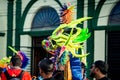 Closeup strong man carries heavy pied mask by city street at dominican carnival