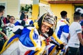 Closeup young man in sparkling costume looks at camera at dominican carnival