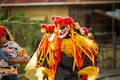 Group of men in clown masks walks under rain by city street at dominican carnival