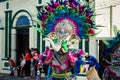 Native man puts on heavy colorful elephant mask on city street at dominican carnival