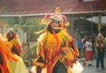 Young man in bright masquerade costume walks by city street at dominican carnival