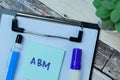 Concept of ABM write on sticky notes isolated on Wooden Table
