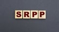 Concept acronym SRPP on wooden cubes on a gray background