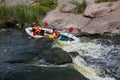 Concept of active recreation. A group of young people is rafting down the river