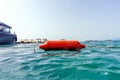 The concept of active recreation and rescue on the water. Buoy on the beach of the Aegean Sea. Selective focus. Royalty Free Stock Photo