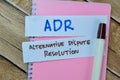 Concept of ADR - Alternative Dispute Resolution write on sticky notes isolated on Wooden Table Royalty Free Stock Photo