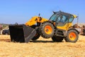 Yellow tractor with a bucket demonstrates work