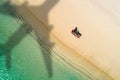 Concept of airplane travel to exotic destination with shadow of commercial airplane flying above beautiful tropical beach. Beach Royalty Free Stock Photo