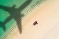 Concept of airplane travel to exotic destination with shadow of commercial airplane flying above beautiful tropical beach. Beach Royalty Free Stock Photo