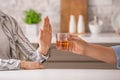 Woman refusing to drink whiskey at home. Concept of alcoholism Royalty Free Stock Photo
