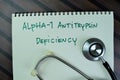 Concept of Alpha-1 Antitrypsin Deficiency write on a book isolated on Wooden Table Royalty Free Stock Photo