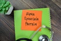 Concept of Alpha Synuclein Protein write on sticky notes isolated on Wooden Table Royalty Free Stock Photo