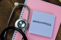 Concept of Amniocentesis write on sticky notes with stethoscope isolated on Wooden Table Royalty Free Stock Photo