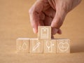 Concept annual health check-up. Hand touch wooden cubes with healthcare medical icons report, blood, syringe, stethoscope, and hea Royalty Free Stock Photo