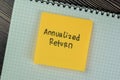 Concept of Annualized Return write on sticky notes isolated on Wooden Table Royalty Free Stock Photo