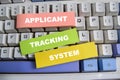 Concept of Applicant, tracking, and system write on sticky notes isolated on keyboard Royalty Free Stock Photo