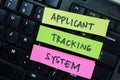 Concept of Applicant tracking System write on sticky notes isolated on Wooden Table Royalty Free Stock Photo