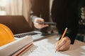 Concept architects or engineer holding pen pointing equipment architects on the desk with a blueprint in the office Royalty Free Stock Photo