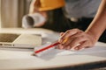 Concept architects or engineer holding pen pointing equipment architects on the desk with a blueprint in the office Royalty Free Stock Photo