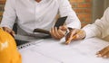 Concept architects or engineer holding pen pointing equipment architects on the desk with a blueprint in the office Royalty Free Stock Photo