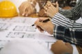 Concept architects or engineer holding pen pointing equipment architects on the desk with a blueprint in the office Royalty Free Stock Photo