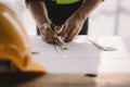 Concept architects or engineer holding pen pointing equipment architects on the desk with a blueprint in the office Royalty Free Stock Photo