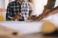 Concept architects or engineer holding pen pointing equipment architects on the desk with a blueprint in the office Royalty Free Stock Photo