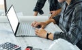 Concept architects, equipment architects, Working On a blank mockup white laptop with a blueprint and Model in the office Royalty Free Stock Photo