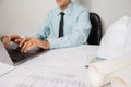 Concept architects, equipment architects ,Working On laptop with a blueprint and Model in the office Selective Focus Royalty Free Stock Photo