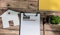 Concept of ARM - Adjustable-Rate Mortgage write on paperwork isolated on wooden background Royalty Free Stock Photo
