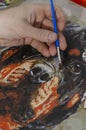 Concept of art, creativity and inspiration - man`s hand with brush paints picture