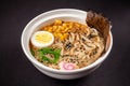 Concept of Asian cuisine. Ramen soup with Chinese noodles, egg, corn, green onions, fish seasoning. Japanese or Chinese dish Royalty Free Stock Photo