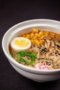 Concept of Asian cuisine. Ramen soup with Chinese noodles, egg, corn, green onions, fish seasoning. Japanese or Chinese dish Royalty Free Stock Photo