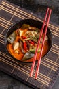 Concept of Asian cuisine. Thai soup Tom yam of chicken broth and coconut milk, mushrooms, chicken, chilli peppers, and vegetables Royalty Free Stock Photo