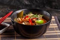 Concept of Asian cuisine. Thai soup Tom yam of chicken broth and coconut milk, mushrooms, chicken, chilli peppers, and vegetables Royalty Free Stock Photo