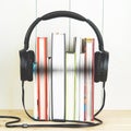 Concept of audio book. headphone and books on white background