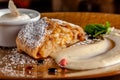 Concept of Austrian cuisine. Apple pie puff pastry. Strudel with apples and cinnamon. Serving dishes in restaurant