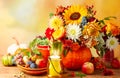 Concept of autumn festive decoration for Thanksgiving day. Autumn bouquet of flowers and berries in a pumpkin on a table, Royalty Free Stock Photo