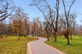 The concept of autumn meditative landscapes. Walking path in the autumn park. Selective focus, horizontal photo.