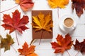 The concept of autumn mood. Morning coffee, diary and colored maple leaves. Top view