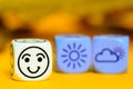 Concept of autumn weather - emoticon and weather dice on orange Royalty Free Stock Photo