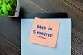 Concept of Back in 5 Minutes write on sticky notes isolated on Wooden Table