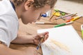 Child sharpening a pencil.