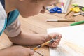 Child sharpening a pencil.