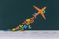 Concept Back to School. Flight of knowledge with airplane and colored letters on the background Royalty Free Stock Photo