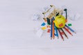 Concept Back to School. Green apple with colored letters and pencils for drawing in a supermarket trolley