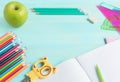 Concept back to school.School accessories, colored pencils, pen with empty notebook on blue wooden background Royalty Free Stock Photo